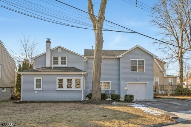 rear view of house featuring a garage