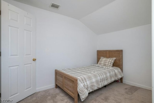 carpeted bedroom featuring lofted ceiling