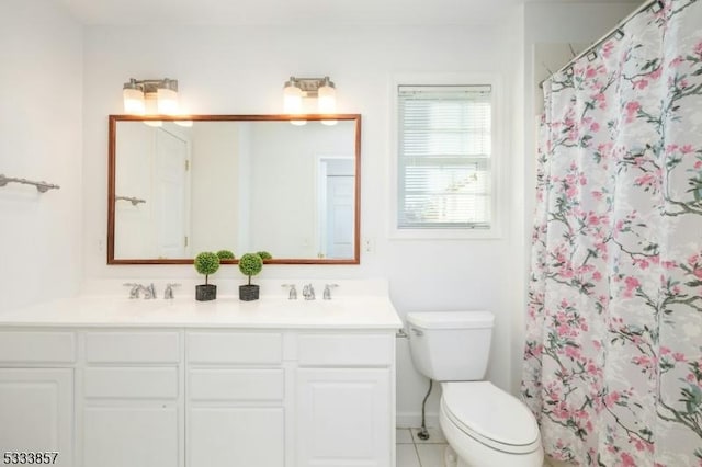 bathroom featuring vanity, toilet, tile patterned floors, and walk in shower