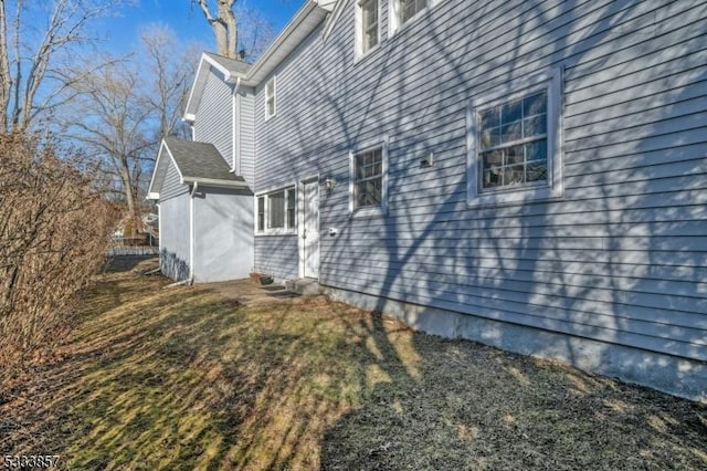 view of side of property with a yard