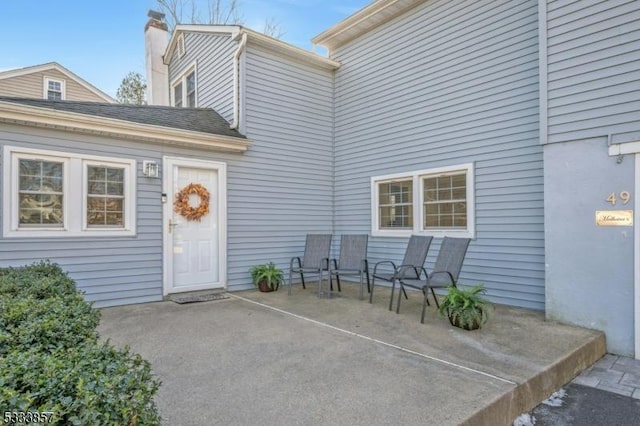 property entrance featuring a patio area