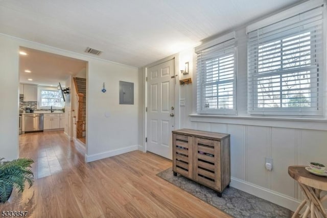 entryway featuring electric panel and light hardwood / wood-style floors