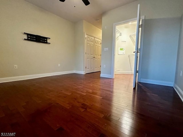 unfurnished room featuring ceiling fan and dark hardwood / wood-style floors