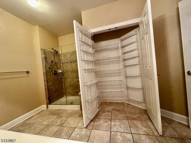 bathroom featuring a shower with door and tile patterned flooring