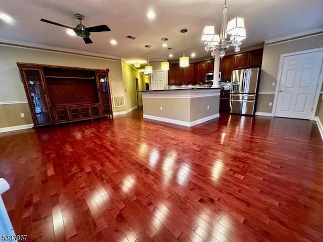 unfurnished living room with ornamental molding, dark hardwood / wood-style floors, and ceiling fan with notable chandelier