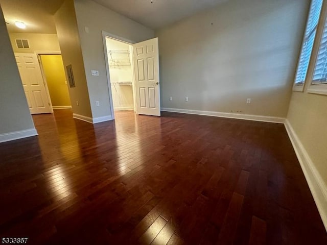 spare room with dark wood-type flooring