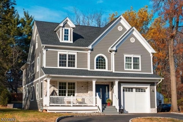 view of front facade featuring covered porch and a garage