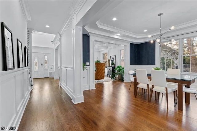 dining room featuring ornamental molding, dark hardwood / wood-style floors, and a tray ceiling