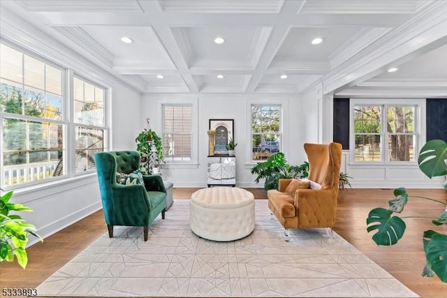 living area with coffered ceiling, light hardwood / wood-style floors, beam ceiling, and a wealth of natural light