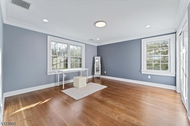 interior space with ornamental molding and wood-type flooring