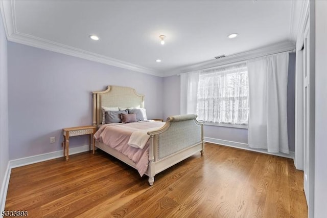 bedroom featuring ornamental molding and wood-type flooring