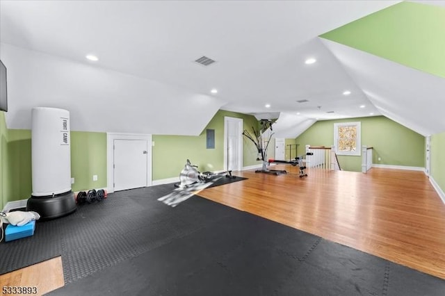 workout room featuring hardwood / wood-style floors and lofted ceiling