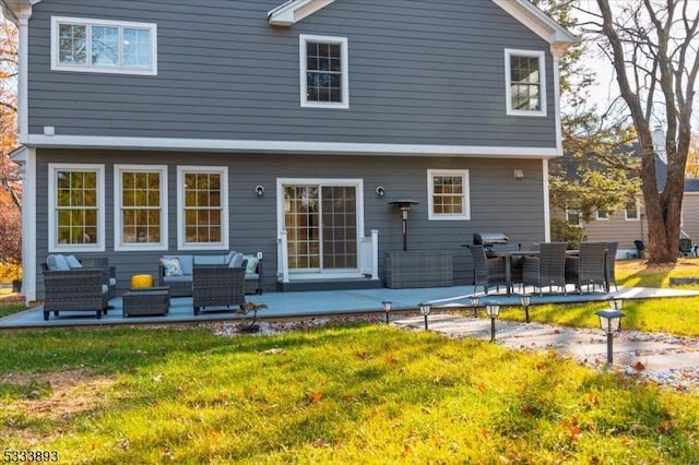 back of property featuring a yard and an outdoor hangout area