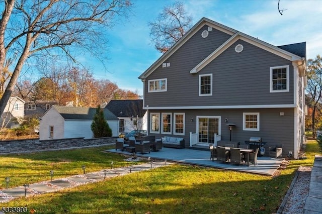 back of house with outdoor lounge area, a yard, and a patio