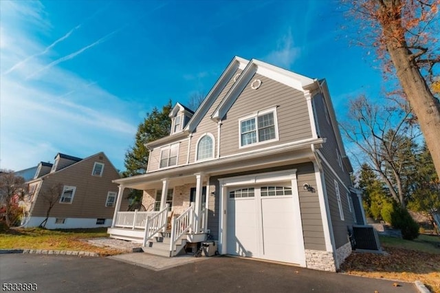 view of front facade with a porch and a garage