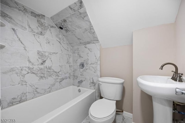 full bathroom with tiled shower / bath combo, lofted ceiling, sink, and toilet