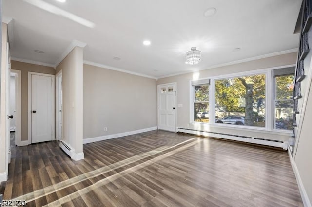 empty room featuring baseboard heating, dark hardwood / wood-style floors, and crown molding