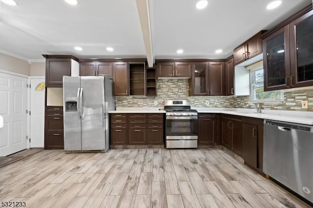 kitchen with appliances with stainless steel finishes, dark brown cabinets, and backsplash