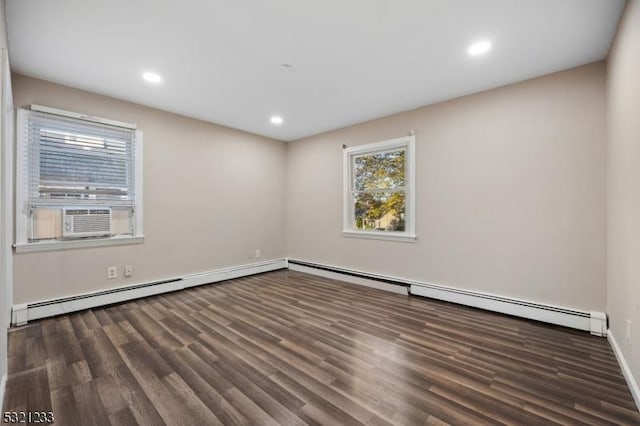 empty room featuring cooling unit, dark hardwood / wood-style flooring, and baseboard heating