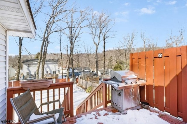 snow covered deck featuring a grill