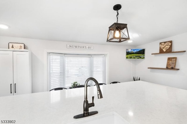 room details featuring pendant lighting and white cabinets