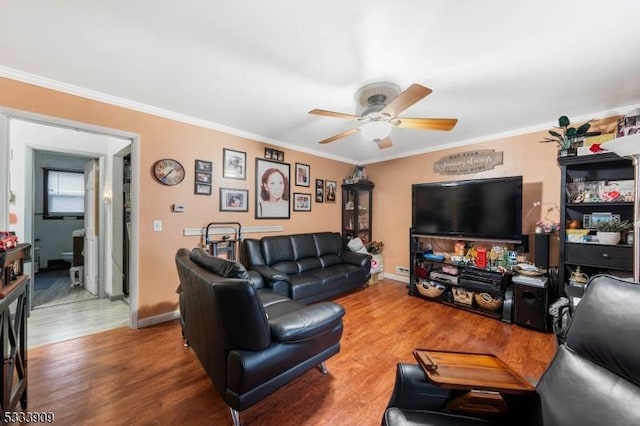 living room with ceiling fan, ornamental molding, and hardwood / wood-style floors