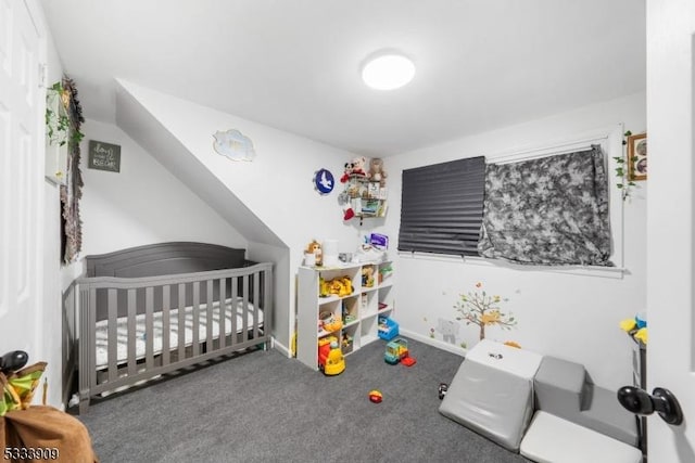 bedroom with a nursery area and dark colored carpet