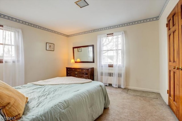 carpeted bedroom with multiple windows