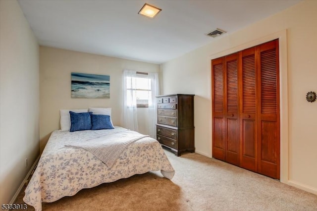 bedroom featuring a closet and light carpet