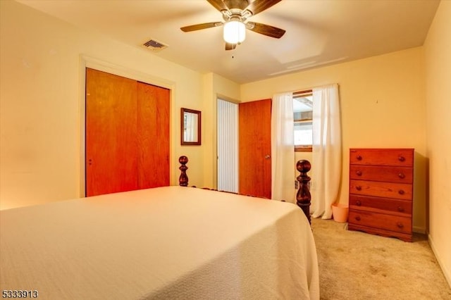 unfurnished bedroom with ceiling fan, a closet, and light carpet