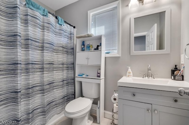 bathroom featuring vanity, curtained shower, and toilet