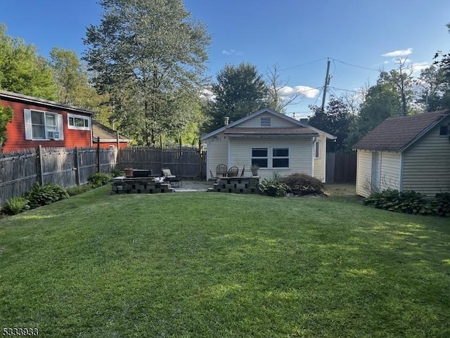 view of yard featuring a fire pit and a storage unit