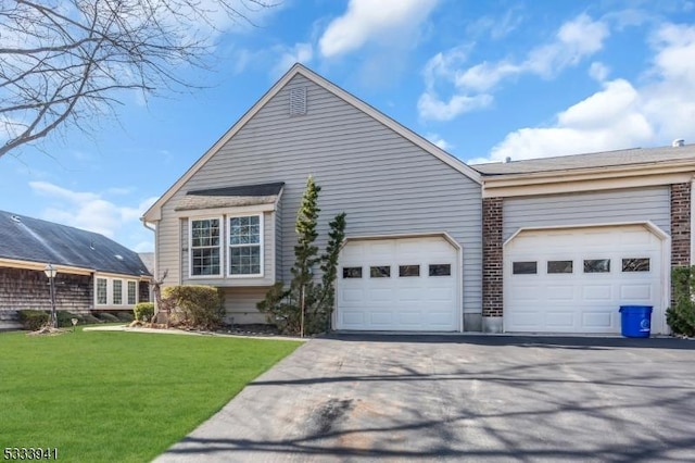 view of front of home with a garage and a front lawn