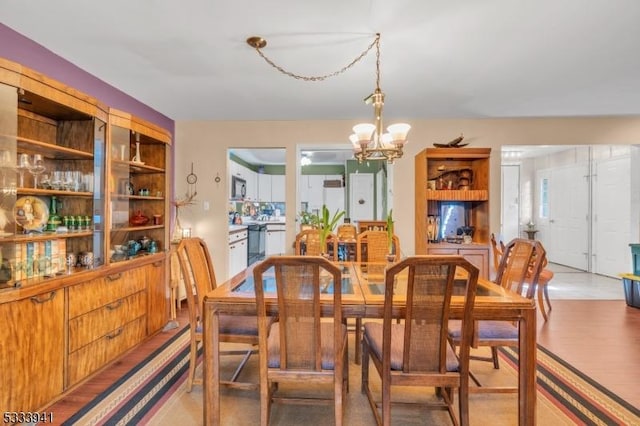 dining room featuring hardwood / wood-style floors and a chandelier