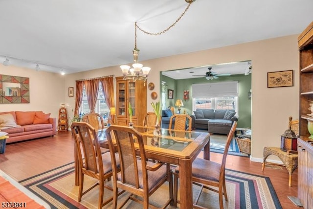 dining room featuring a notable chandelier, hardwood / wood-style flooring, and a healthy amount of sunlight