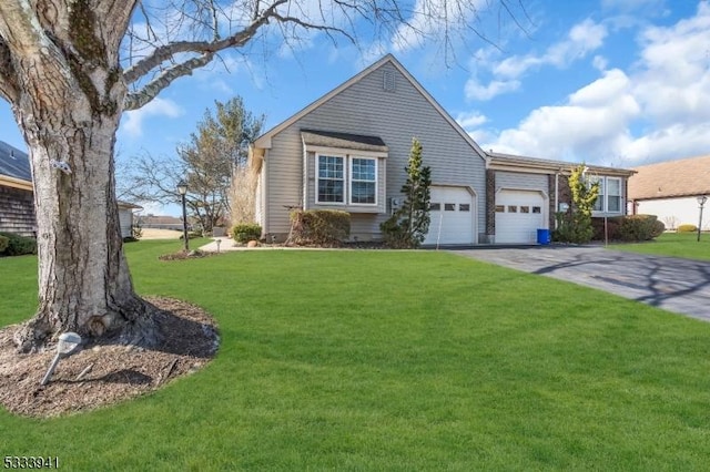 view of front of property with a garage and a front yard