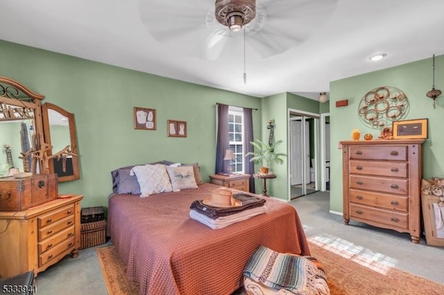 carpeted bedroom with a closet and ceiling fan