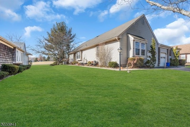 view of property exterior featuring a garage and a lawn