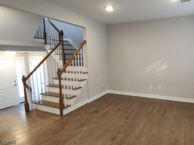 staircase featuring wood-type flooring