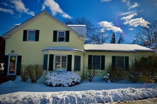 view of snow covered rear of property