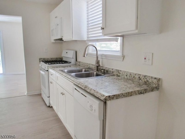 kitchen featuring white appliances, a sink, white cabinets, and light countertops