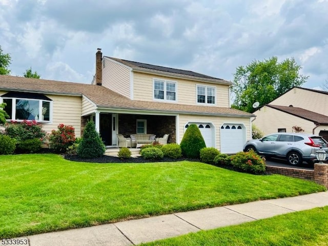 view of front of house featuring an outdoor living space, an attached garage, driveway, and a front lawn