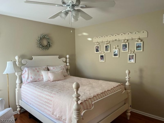 bedroom with baseboards, wood finished floors, and a ceiling fan