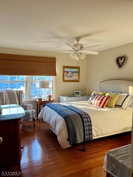 bedroom with a ceiling fan and wood finished floors