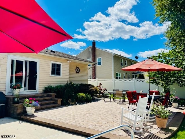 view of patio featuring outdoor dining space and fence