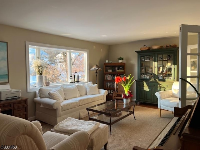 living area with light wood-style floors and baseboards