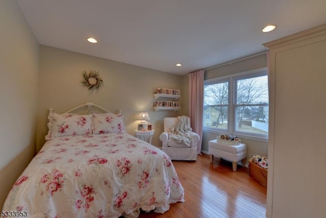 bedroom with recessed lighting and wood finished floors