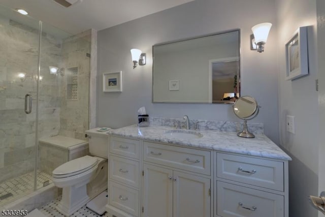 bathroom with vanity, toilet, and a shower stall