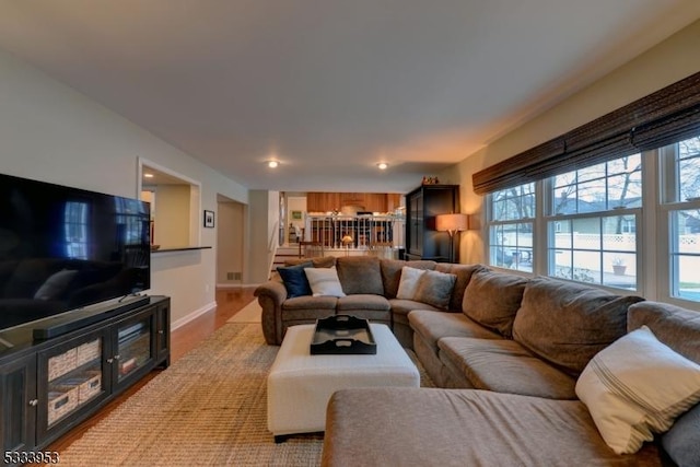 living room with light wood-type flooring and baseboards