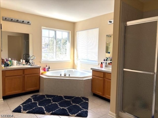 bathroom with independent shower and bath, vanity, and tile patterned floors